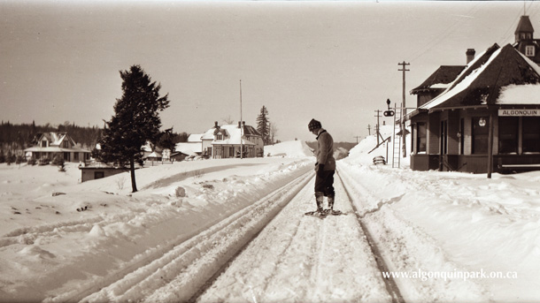 Snowshoer standing on the railroad tracks, Algonquin Park Station, Cache Lake, 1915. APPAC, 1995.1.10, Harry and Adele Ebbs.